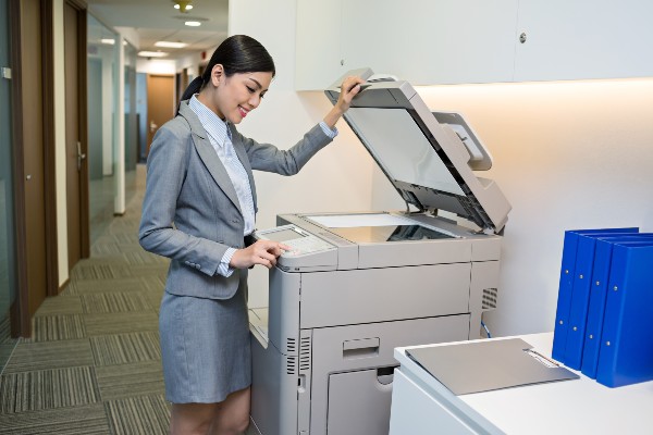 woman using copier in small business setting